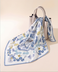 Blue Floral Medallion silk scarf tied to a handbag